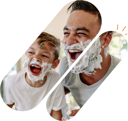 father and son with shaving foam in their faces laughing